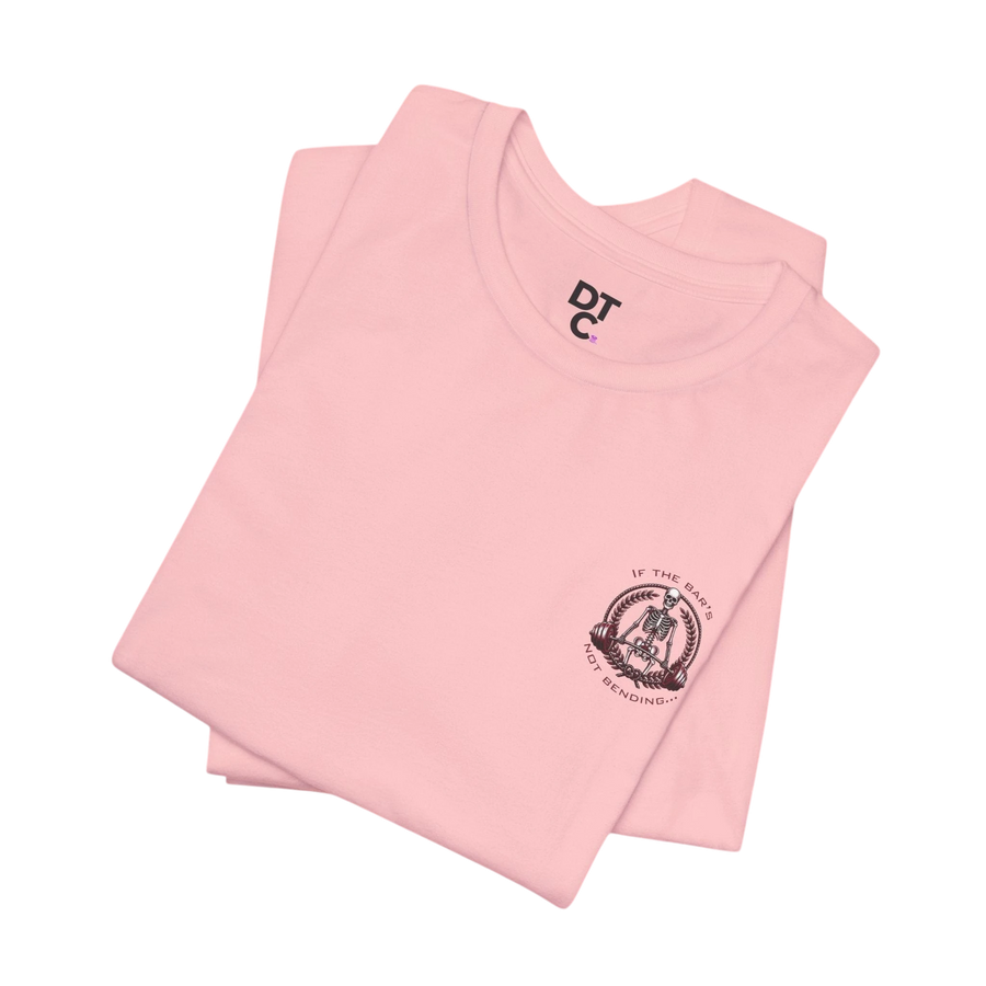 DailyThreadCo. light pink 100% cotton crew neck t-shirt with a small chest graphic of a skeleton lifting weights.
