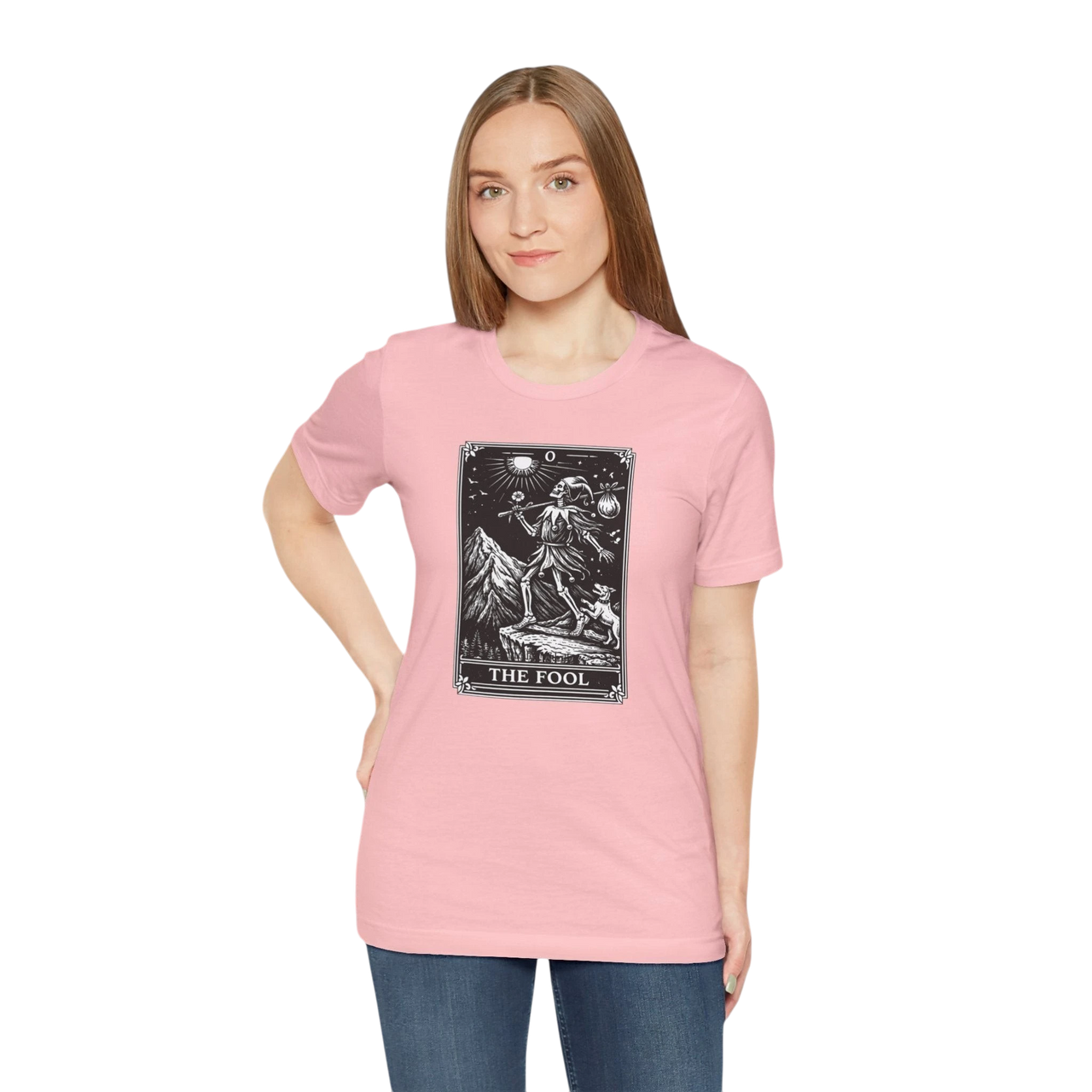 DailyThreadCo. pink cotton t-shirt with a black and white graphic of The Fool tarot card, featuring a skeleton figure on a mountain with celestial symbols.