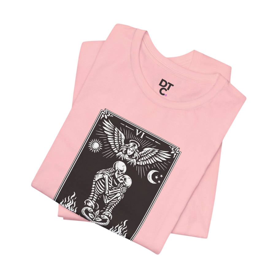 DailyThreadCo. pink cotton t-shirt with black and white 'The Lovers' tarot card graphic featuring skeletons, an angel, sun, moon, and flames.