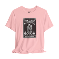 DailyThreadCo. pink cotton t-shirt with a black and white graphic of The Lovers tarot card, featuring skeleton figures, an angel, sun, moon, and flames.