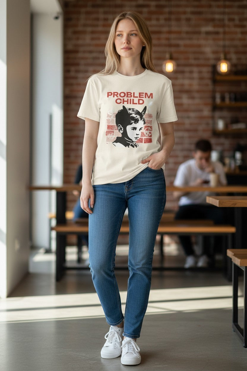 DailyThreadCo. cream 100% cotton t-shirt with a retro punk graphic of a child with devil horns and the words "PROBLEM CHILD" in red.
