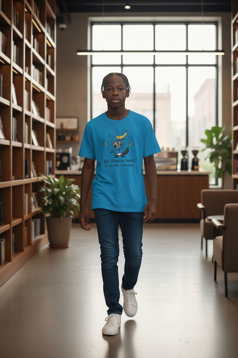 DailyThreadCo. blue cotton t-shirt with a graphic of a raccoon holding a banana and the text "Big Financial Moves (I secured a banana)".