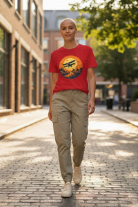 DailyThreadCo. red cotton t-shirt with vintage biplane graphic over desert landscape at sunset.