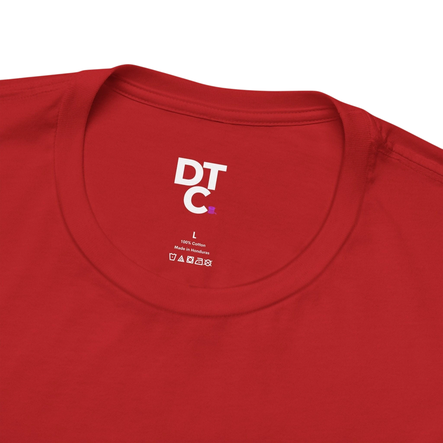 DailyThreadCo. red 100% cotton t-shirt with a graphic print on the back and a small chest emblem. Features a crew neck and short sleeves.