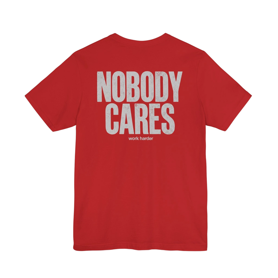 DailyThreadCo. red 100% cotton graphic tee with white "NOBODY CARES" and "work harder" text on back. Crew neck, short sleeves.