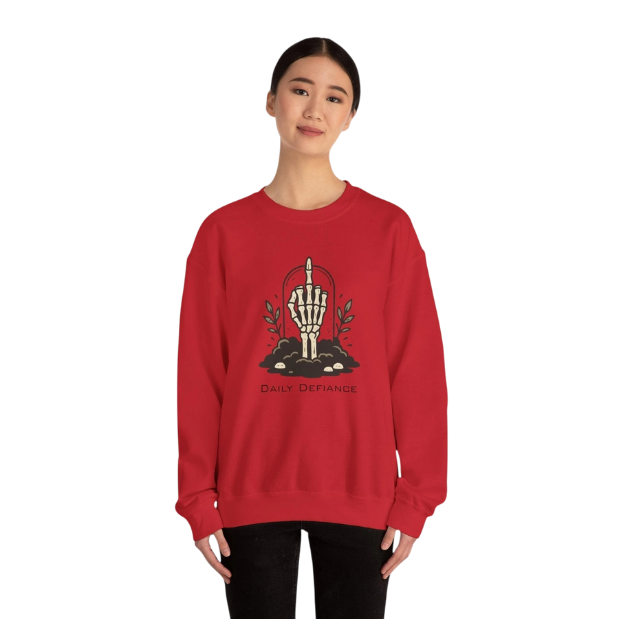 DailyThreadCo. red crewneck sweatshirt with a skeleton hand graphic giving the middle finger, surrounded by foliage and the words "Daily Defiance."