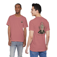 DailyThreadCo. Muted rose 100% cotton t-shirt with a skeleton hand graphic on the back and a small chest emblem. Features a vintage, rebellious style.
