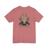 DailyThreadCo. Muted rose 100% cotton t-shirt with a graphic of a skeleton hand rising from the ground with leaves and the text Daily Defiance.
