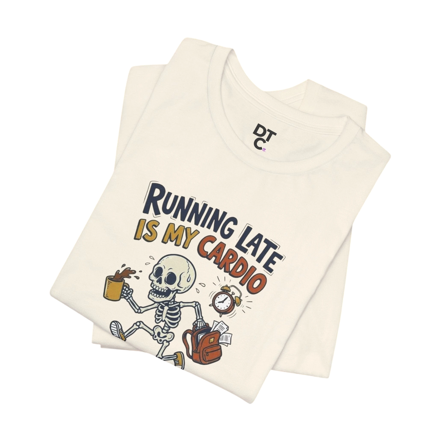 DailyThreadCo. cream cotton t-shirt with a cartoon skeleton running late, holding coffee and a backpack, with the text "Running Late Is My Cardio".