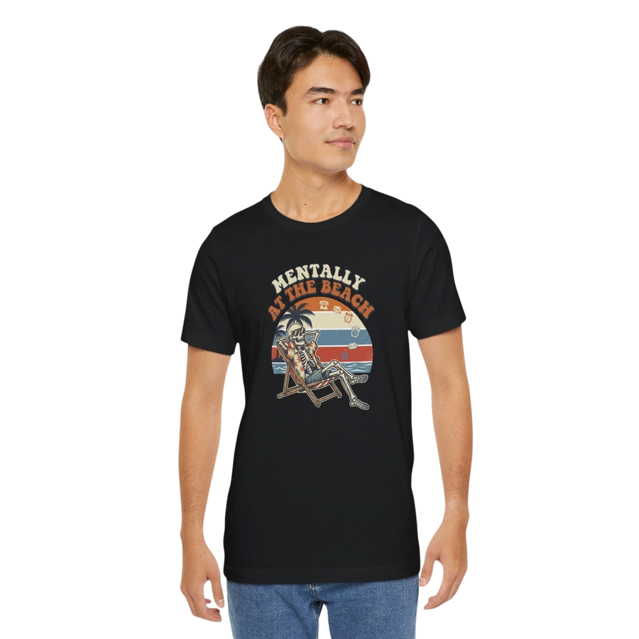 DailyThreadCo. black 100% cotton t-shirt with a retro graphic of a skeleton relaxing on a beach chair under palm trees, text reads "Mentally at the Beach".
