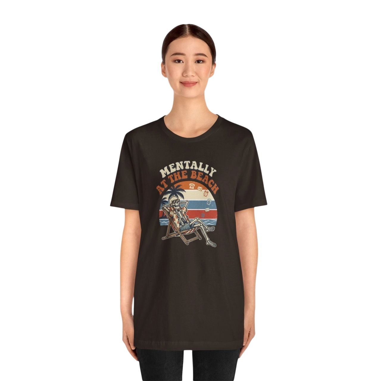 DailyThreadCo. dark brown 100% cotton t-shirt with a retro graphic of a skeleton relaxing in a beach chair under a palm tree, text reads "Mentally at the Beach".