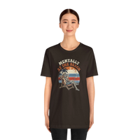 DailyThreadCo. dark brown 100% cotton t-shirt with a retro graphic of a skeleton relaxing in a beach chair under a palm tree, text reads 