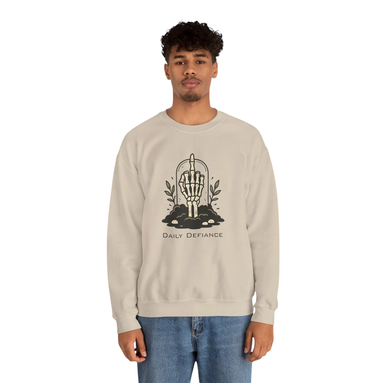 DailyThreadCo. beige crewneck sweatshirt with a black graphic of a skeleton hand giving the middle finger emerging from the ground with foliage and the words "Daily Defiance".