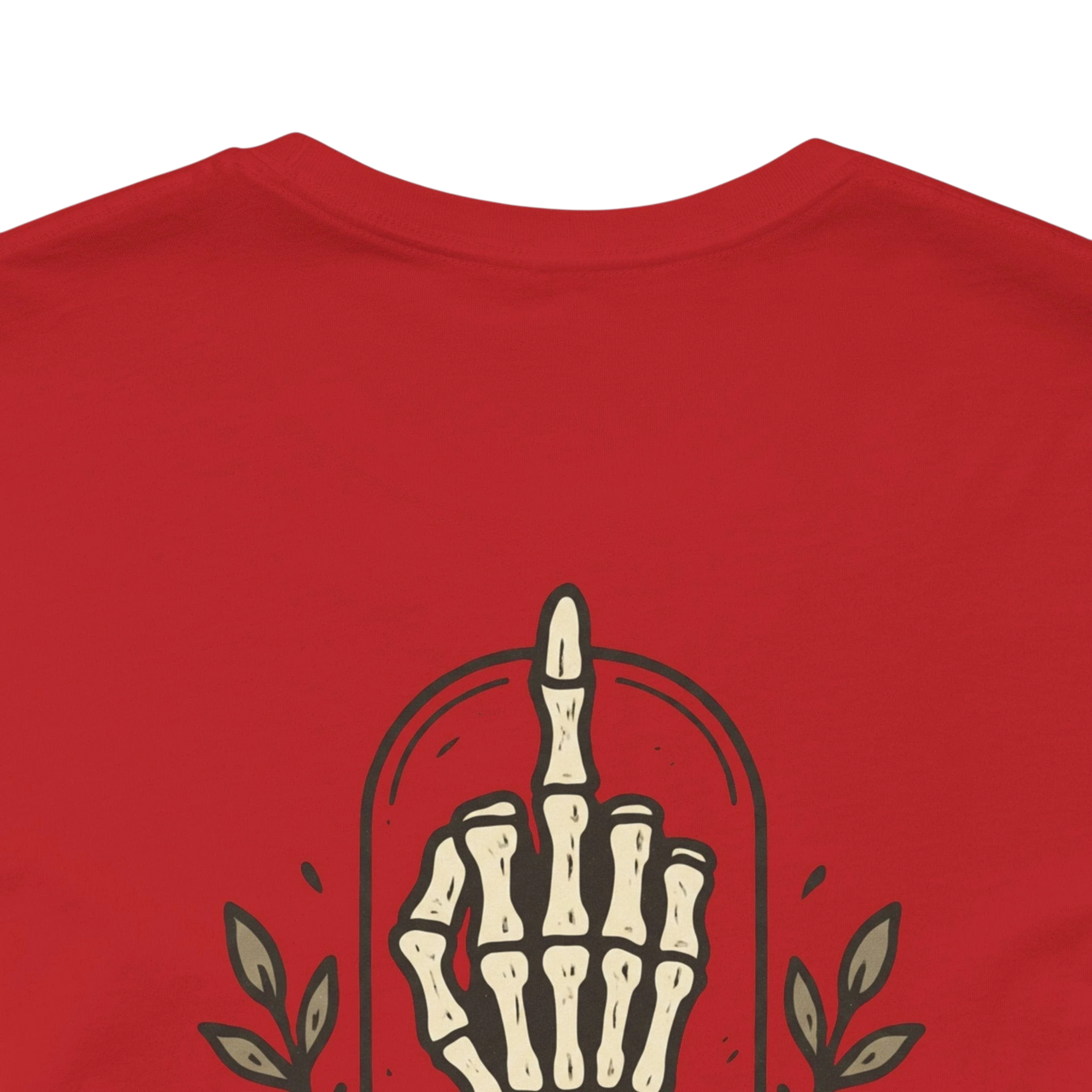 DailyThreadCo. Muted rose 100% cotton t-shirt with a skeleton hand graphic giving the middle finger and "Daily Defiance" text.