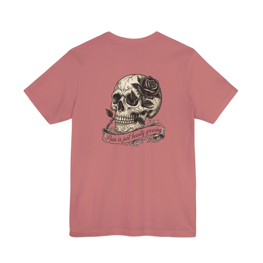 DailyThreadCo. dusty rose 100% cotton graphic tee with a vintage skull and rose design and the text "Pain is just beauty growing" on the back.