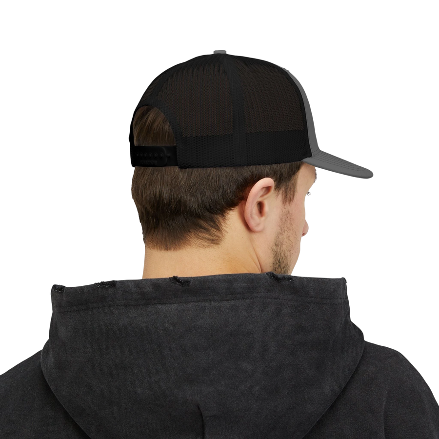 DailyThreadCo. black and grey trucker cap with distressed skull emblem and 'DEADWEIGHT' logo. Mesh back for breathability.