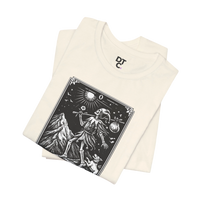 DailyThreadCo. cream cotton t-shirt with 'The Fool' tarot card graphic print in black and white, featuring a skeleton figure, mountain, sun, and dog.
