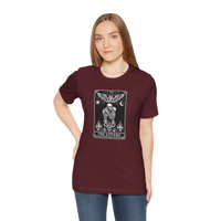 DailyThreadCo. maroon cotton t-shirt with a black and white tarot card graphic of The Lovers, featuring skeleton figures, angelic wings, sun, moon, and flames.