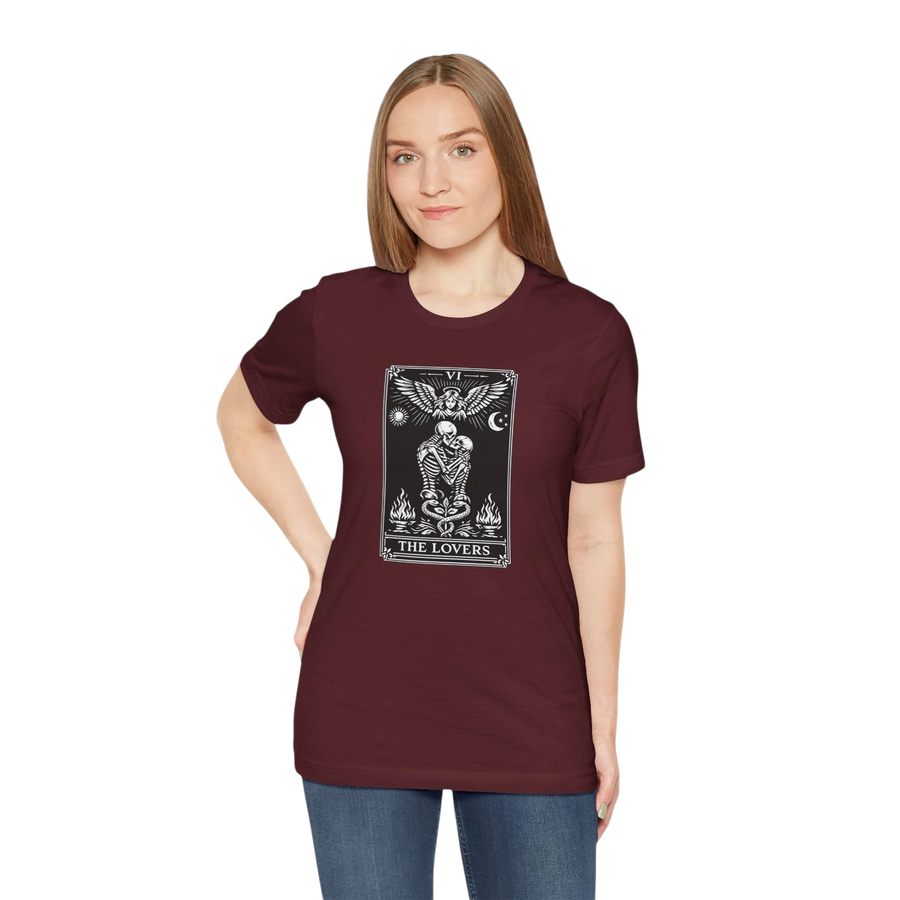 DailyThreadCo. maroon cotton t-shirt with a black and white tarot card graphic of The Lovers, featuring skeleton figures, angelic wings, sun, moon, and flames.