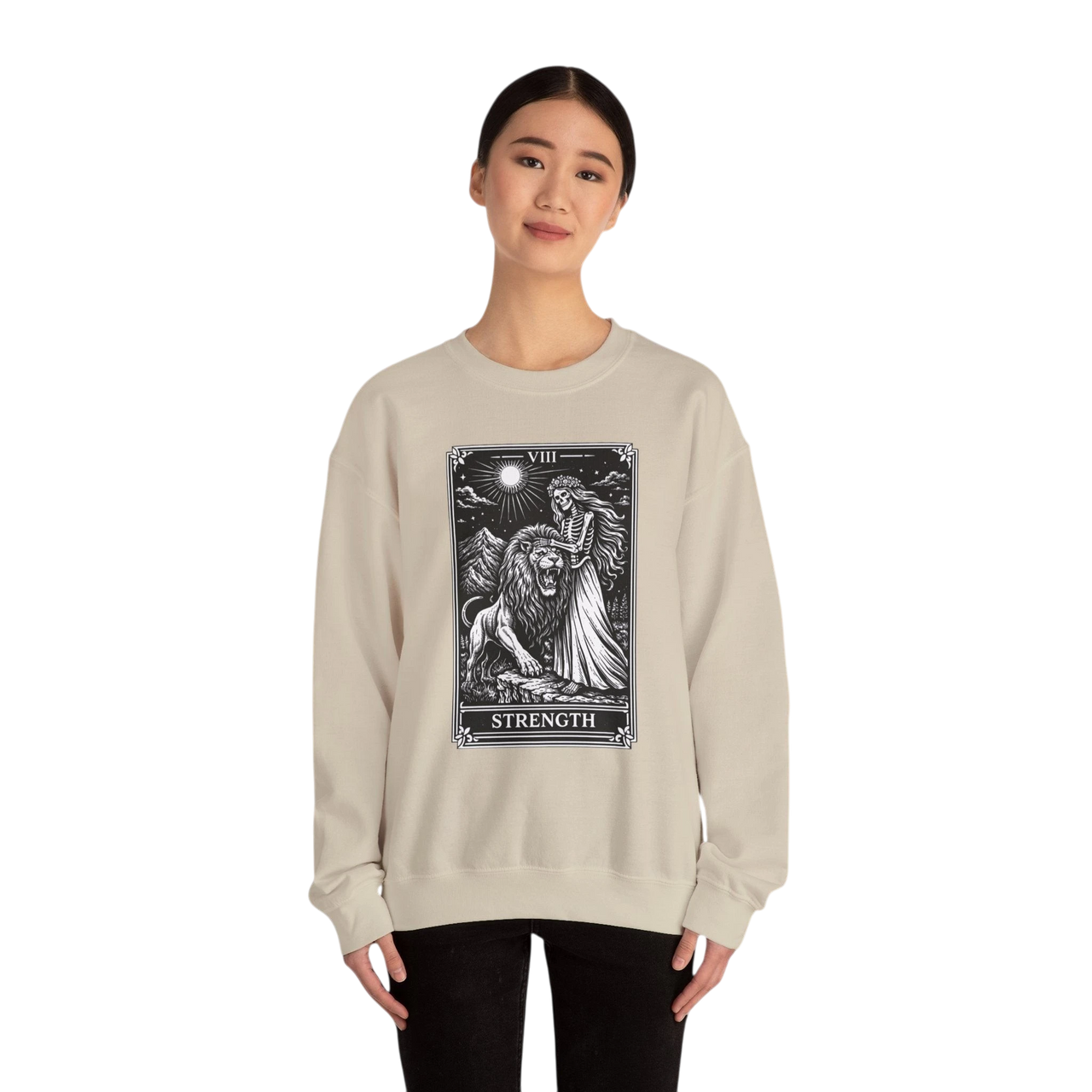 DailyThreadCo. beige crewneck sweatshirt with a black tarot strength card graphic featuring a woman and a lion.