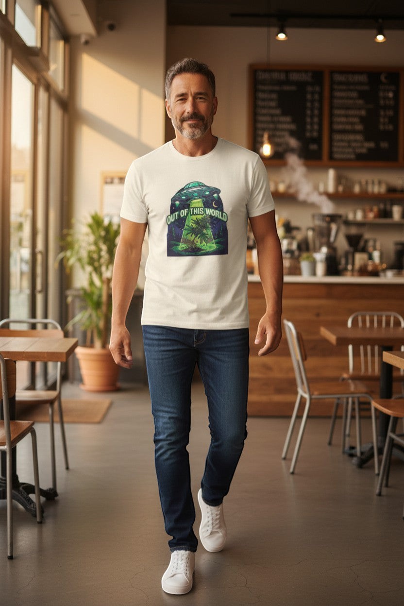 DailyThreadCo. cream cotton t-shirt with a graphic of a UFO beaming up a cannabis plant under a starry sky. Text reads "OUT OF THIS WORLD".