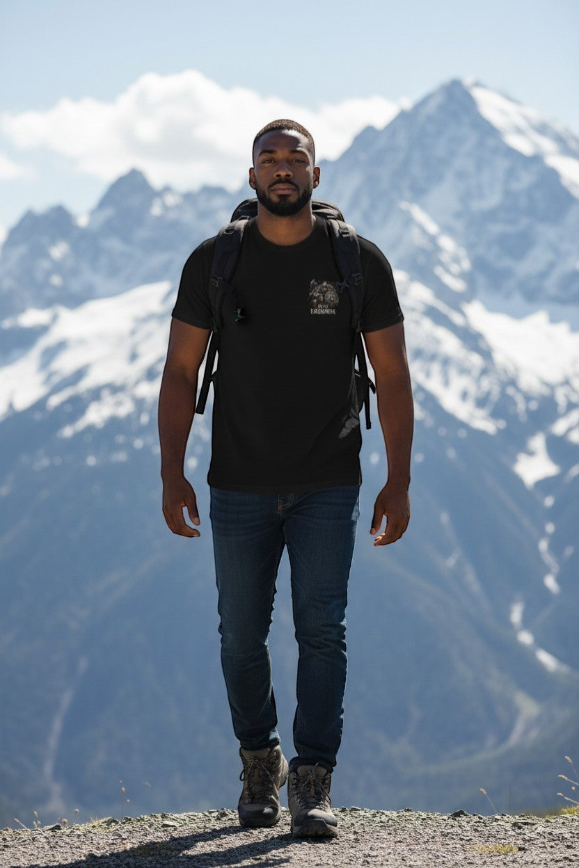 DailyThreadCo. black 100% cotton t-shirt with a Viking warrior graphic on the back and "Until Ragnarok" text. Model is wearing it with jeans and hiking boots.