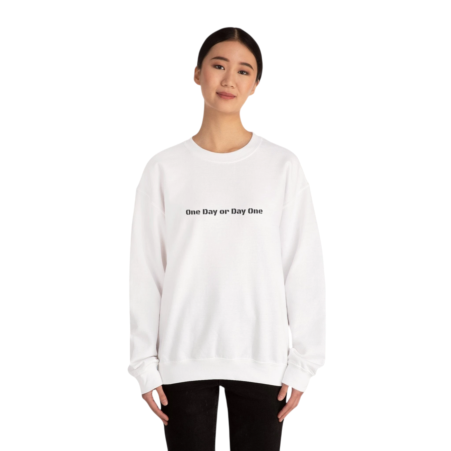 DailyThreadCo. white crewneck sweatshirt with black text "One Day or Day One" on the front. Made from a cotton-blend.