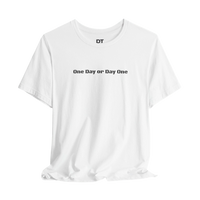 DailyThreadCo. white 100% cotton crew neck t-shirt with black text graphic 'One Day or Day One' and 'DT' logo on the collar.