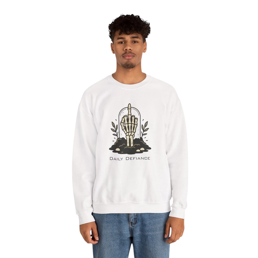 DailyThreadCo. white crewneck sweatshirt with a graphic of a skeleton hand giving the middle finger emerging from the ground, surrounded by foliage and the text "Daily Defiance."